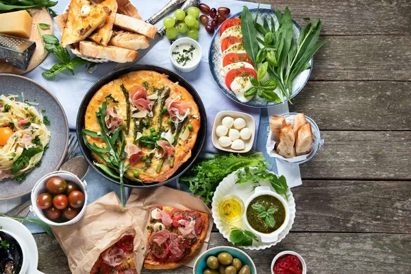 Delicious buffet catering spread with kebabs, roasted vegetables, and fresh salads at Glenny Kebabs.