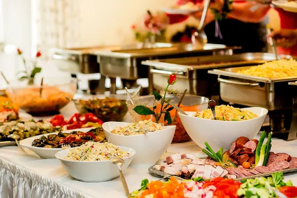 Delicious buffet catering spread with kebabs, roasted vegetables, and fresh salads at Glenny Kebabs.