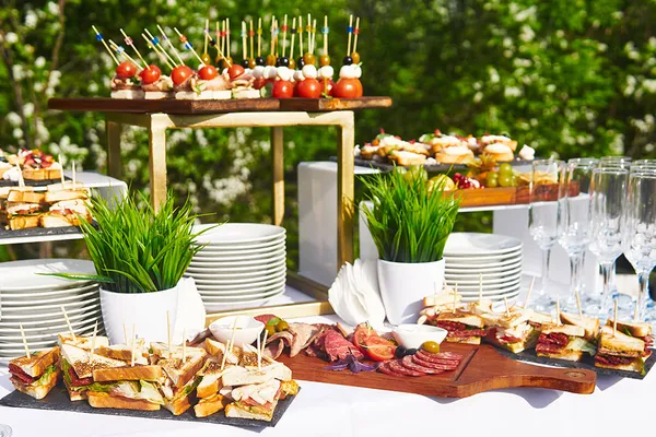 Delicious buffet catering spread with kebabs, roasted vegetables, and fresh salads at Glenny Kebabs.