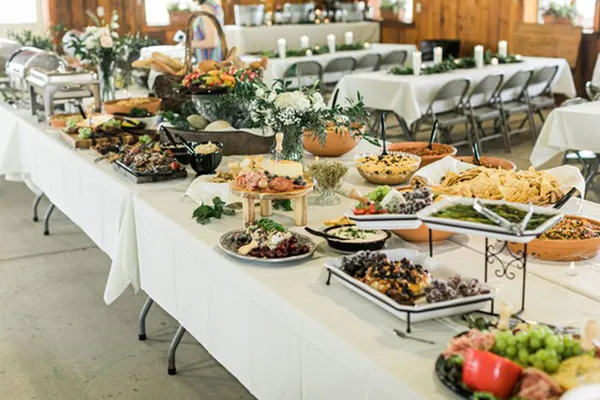 Delicious buffet catering spread with kebabs, roasted vegetables, and fresh salads at Glenny Kebabs.