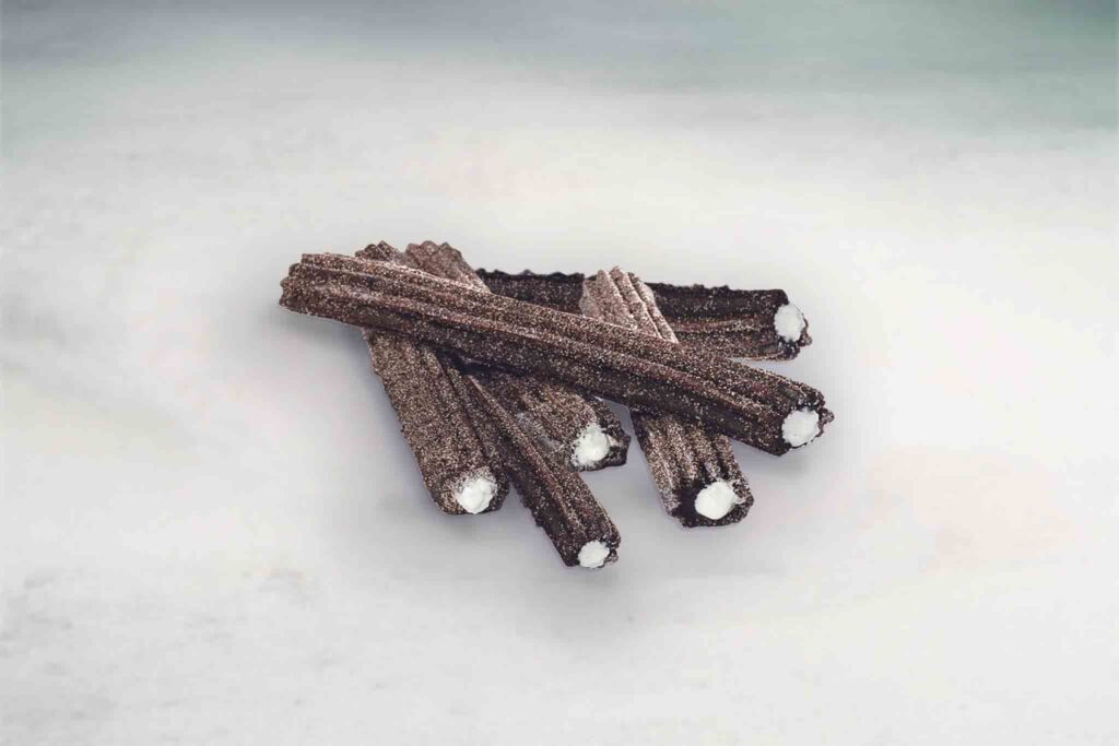 Oreo churros filled with cream and coated in cinnamon sugar for a delicious, sweet snack.