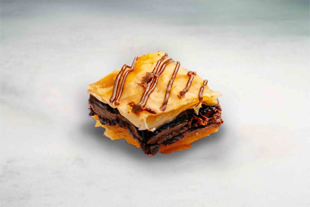Baklava filled with Nutella, made with crispy layers of phyllo pastry and served in bite-sized pieces for a sweet, indulgent dessert.