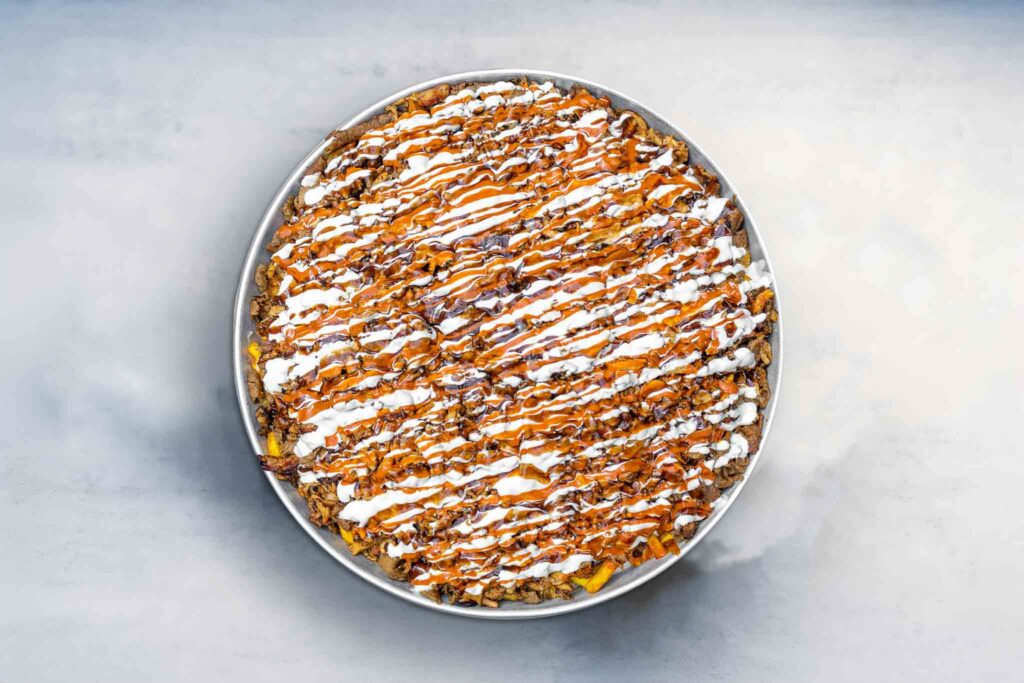 Image of the Big Fat HSP, a massive Halal Snack Pack with crispy chips, melted cheese, tender meat, and sauce, perfect for large gatherings or events.