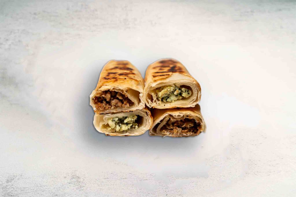 Golden, flaky Börek pastry filled with spinach and ricotta or savory beef and onion, offering a delicious Mediterranean snack or meal.