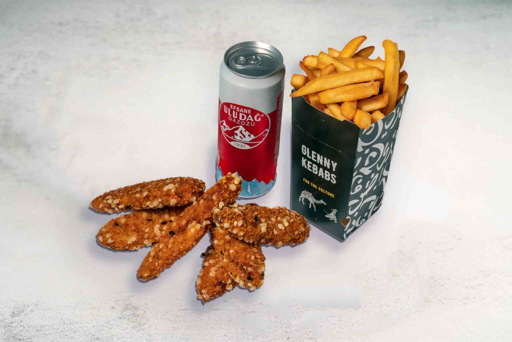 A serving of 6 crispy chicken tenders with seasoned chips and a soft drink can, a delicious and satisfying meal option.