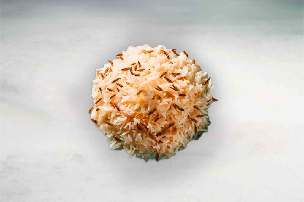 Cumin-infused long grain Basmati rice served in a bowl, showcasing fluffy grains with a hint of aromatic cumin seasoning.