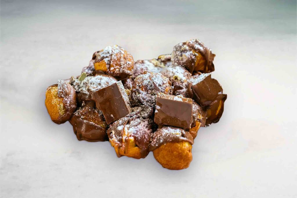 Freshly baked and fried donut pieces coated in Nutella, topped with a variety of sweet toppings in a Donut Snack Pack.
