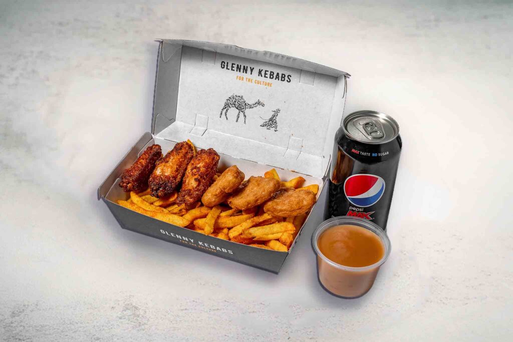 Image of the Glenny Fried Chicken Box, featuring seasoned chips, chicken wings, chicken nuggets, gravy, and a soft drink.