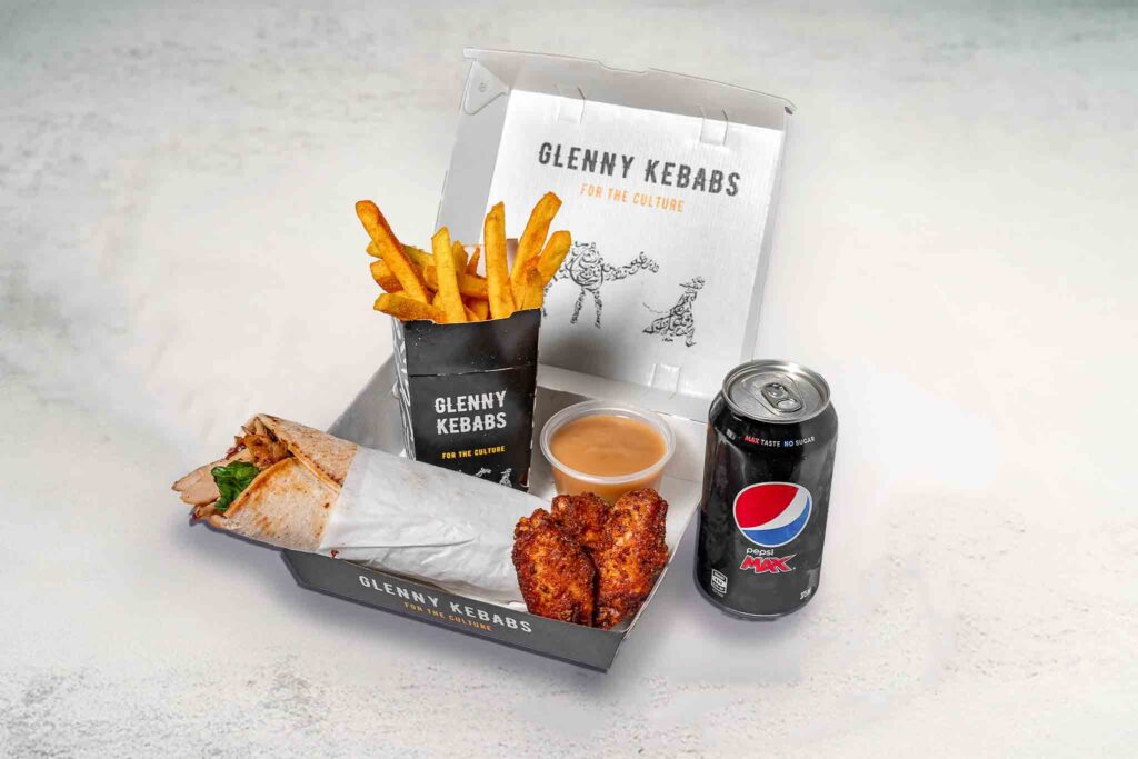 Image of the Halal Box featuring grilled kebab, crispy seasoned chips, chicken wings, savory gravy, and a soft drink.