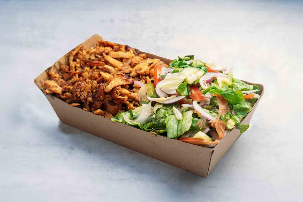 Meat & Salad dish with tender lamb, juicy chicken, or both, served with a vibrant garden salad of lettuce, tomatoes, cucumbers, and red onions.