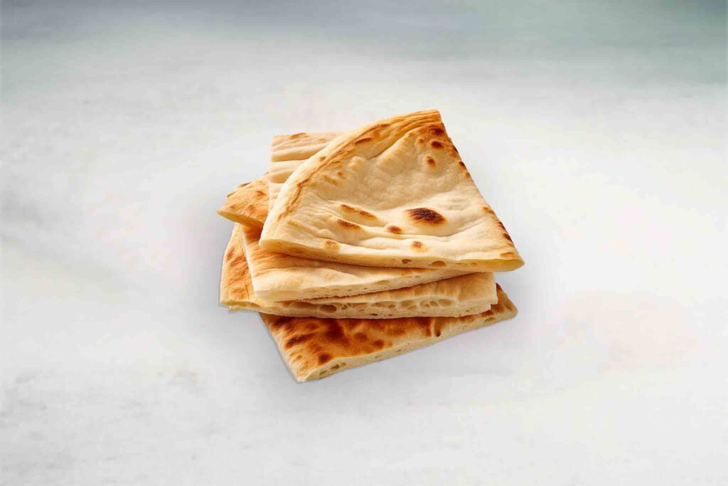 Thick and fluffy Mediterranean-style pita bread, with a soft interior and lightly crispy exterior, perfect for wraps and dipping.