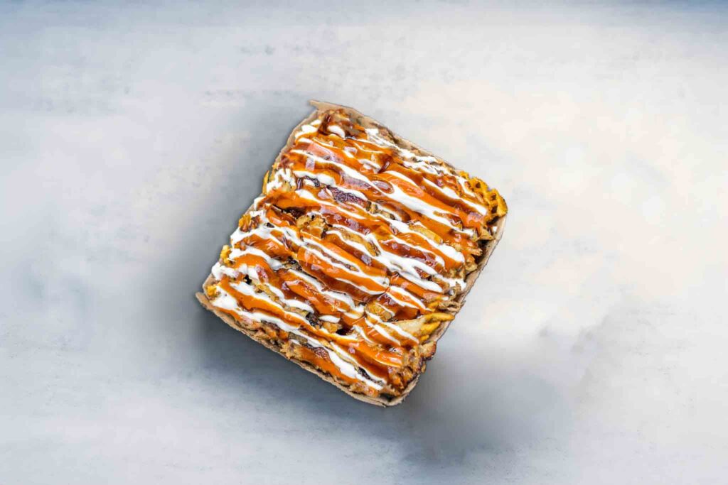 Small Halal Snack Pack with golden fries, mozzarella cheese, tender lamb, chicken, or mixed meat, topped with flavorful sauces.