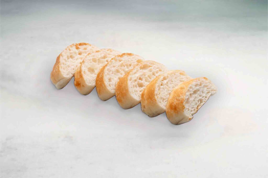 A warm, freshly baked loaf of Turkish bread with a soft interior and crispy crust, perfect for dipping or pairing with meals.