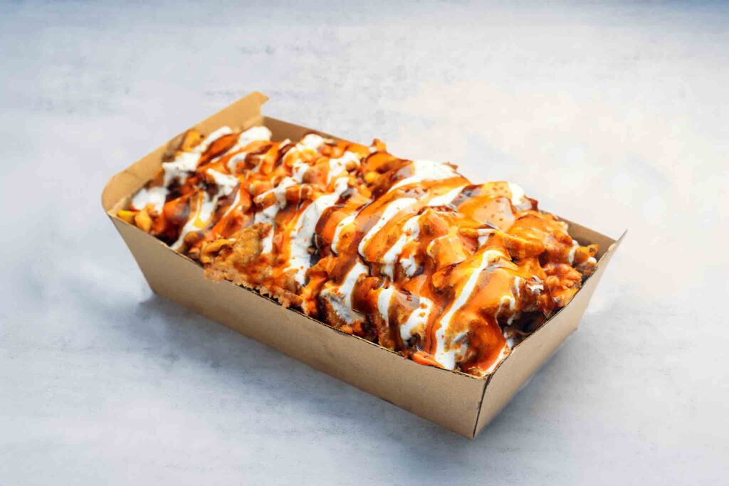 Image of a Vegan HSP with golden fried chips, mozzarella cheese, choice of lamb, chicken, or mixed meat, topped with sauces and extras, served with optional upgrades.