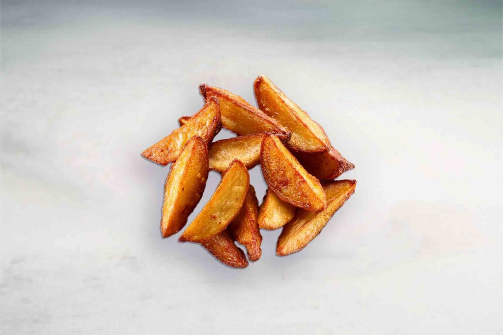 Image of crispy thick-cut wedges served with sweet chili and sour cream dipping sauces.