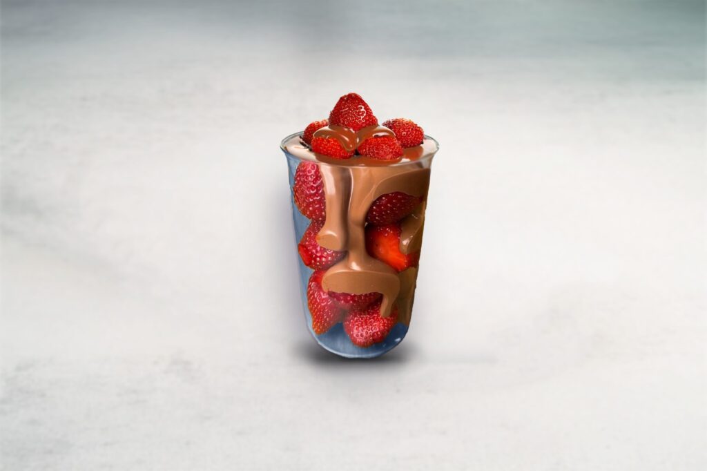 Strawberry cup filled with fresh strawberries and drizzled with Nutella, offering a sweet and fruity dessert.